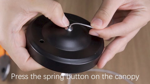 Press the spring button on the canopy