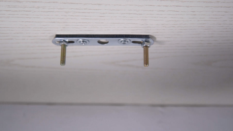 The first step is to fix the base to the ceiling