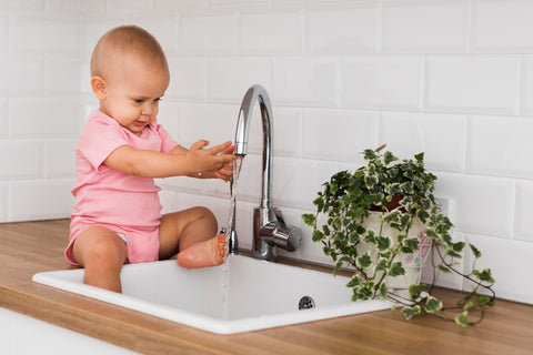 baby washing hands to prevent infectious diseases