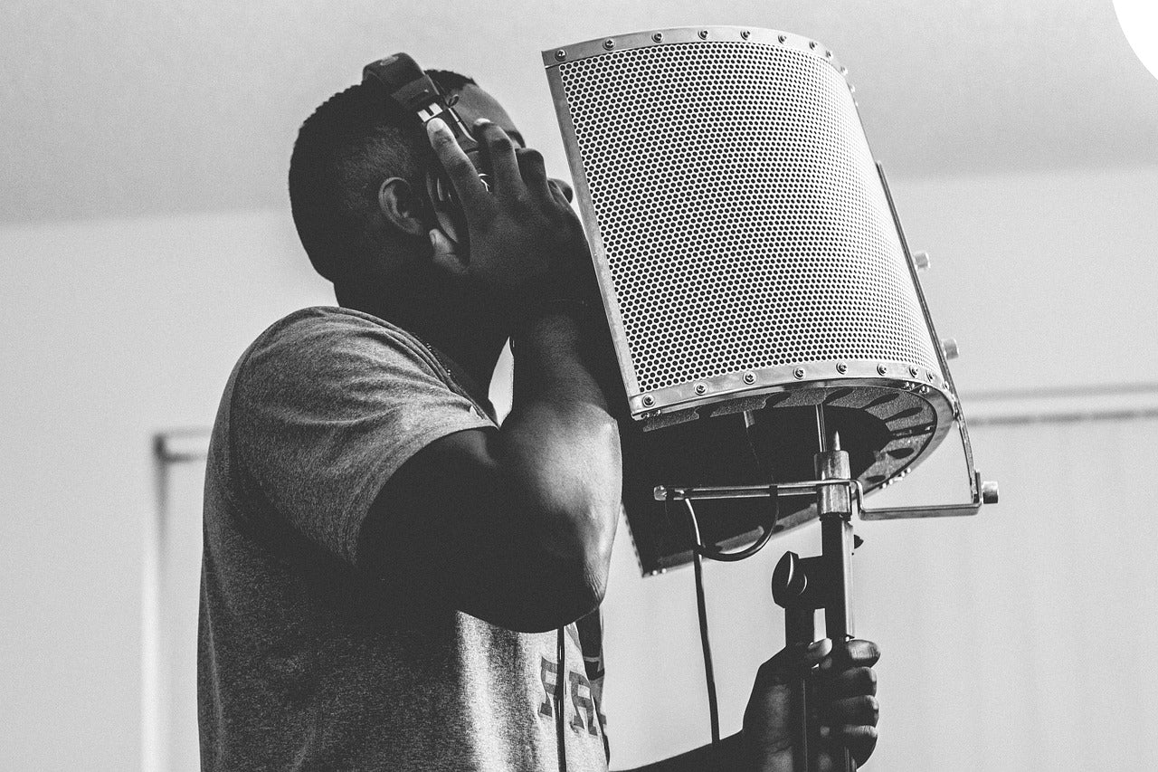 guy singing with ANC headphones