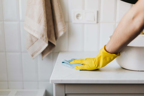 crop-housewife-cleaning-surface-near-sink