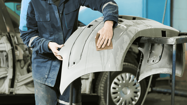 A man cleaning a Gray Front Bumer Cover