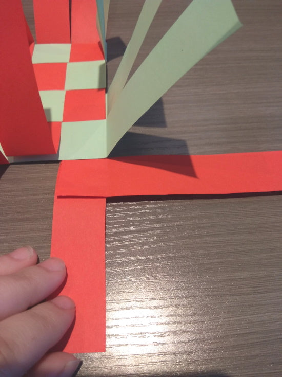 Taping the first side weaving strip at the basket corner