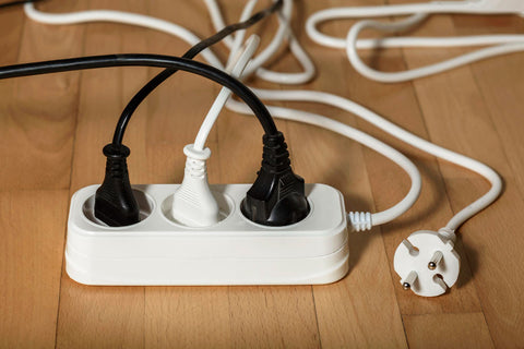 extension-cord-with-multiple-plugs-power-plugs-wooden-background