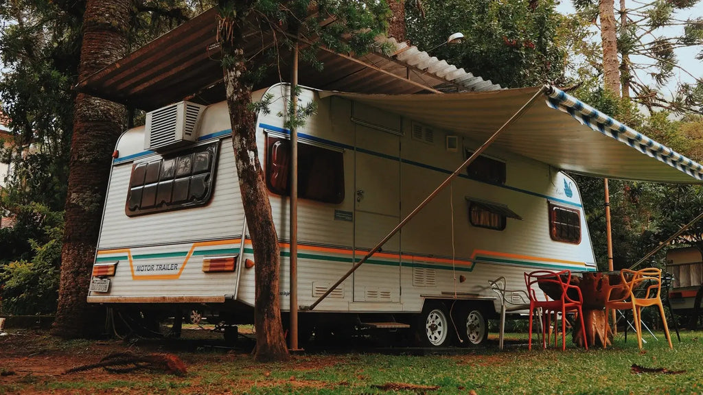An RV parked in the shade