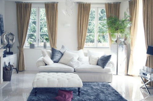 Window treatments embellish the look with natural fibers such as silk, linen and brocade. Large antique area rugs define spaces within a room. Glass and crystal lighting complement the look. The space is ordered, cohesive and comfortably elegant.