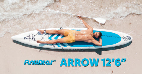 A man lying on Funwater Arrow 12'6" inflatable paddle board