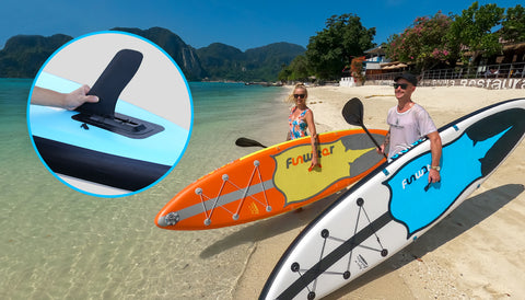 2 person with their paddle boards and take care of the fins on boards
