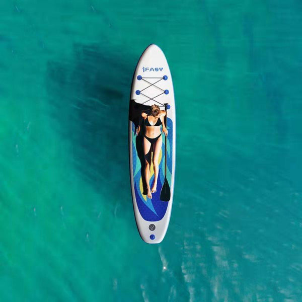 A woman lying on a paddle board