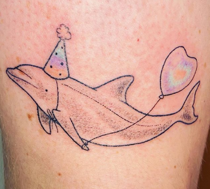 dolphin tattoo design with balloon and cone hat
