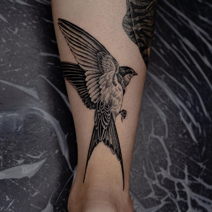 swallow tattoo on the calf