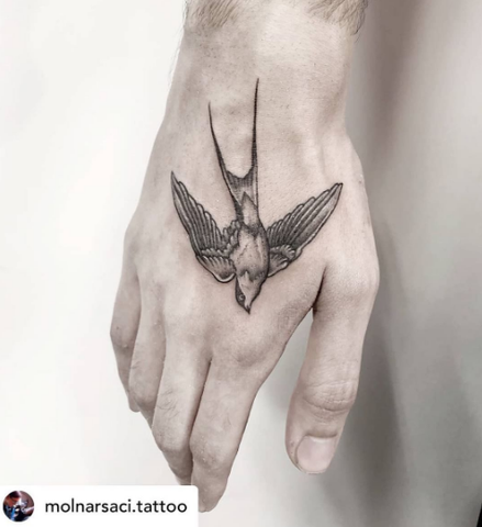swallow tattoo on the hand