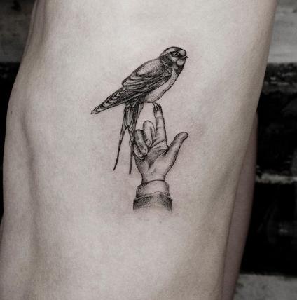tattoo of swallow on the fingertip