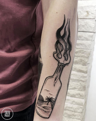 tattoo of beach scene in a Molotov cocktails