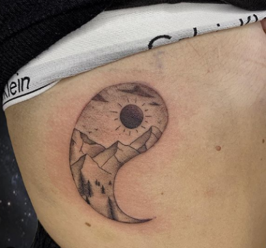 tattoo of mountain and sun in a Bagua frame
