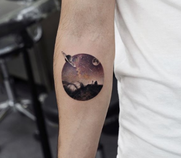 tattoo of universe in a circular frame