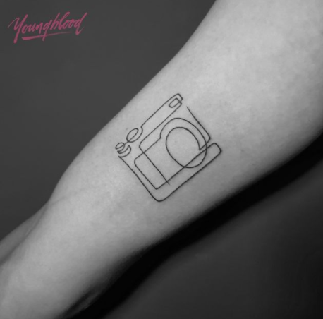 camera tattoo design on the arm