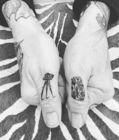 camera tattoo design on the fingers
