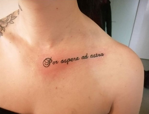 latin tattoo on the collarbone
