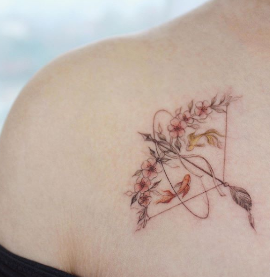 floral bow and arrow tattoo on chest