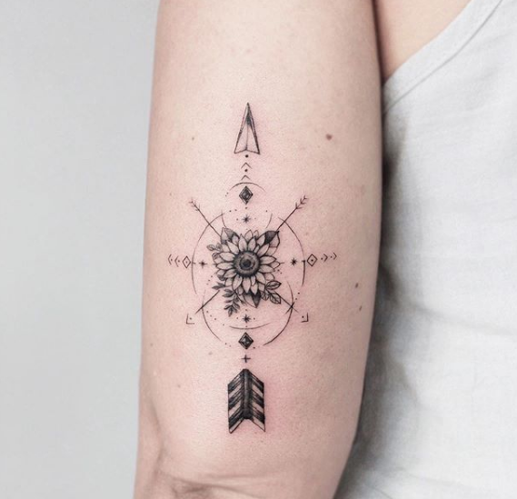 sunflower and arrow arm tattoo