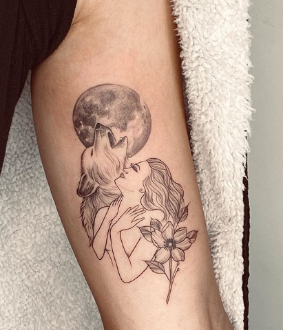woman and wolf tattoo on arm