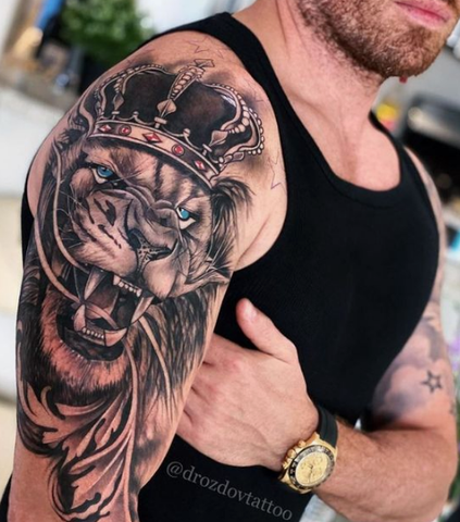 lion crown arm tattoo