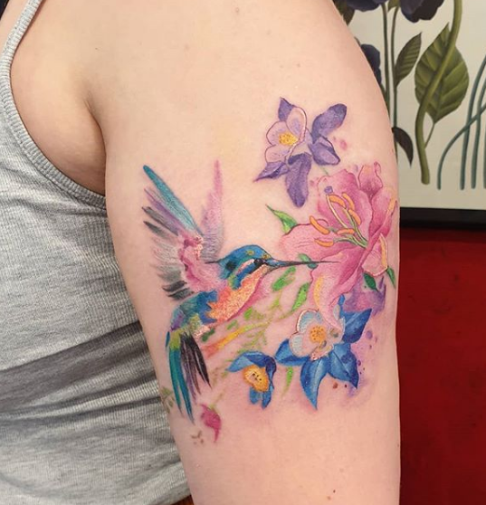 flower and hummingbird arm tattoo