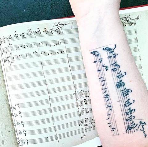 music staff forearm tattoo