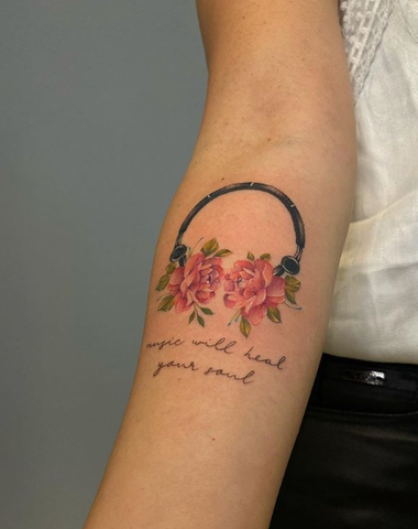 decorated flower floral headphone forearm tattoo