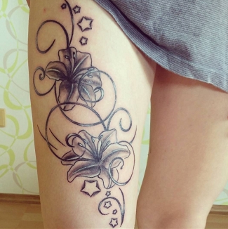 lily flower thigh tattoo