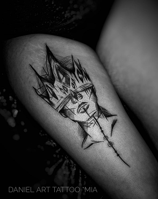 portrait with crown thigh tattoo