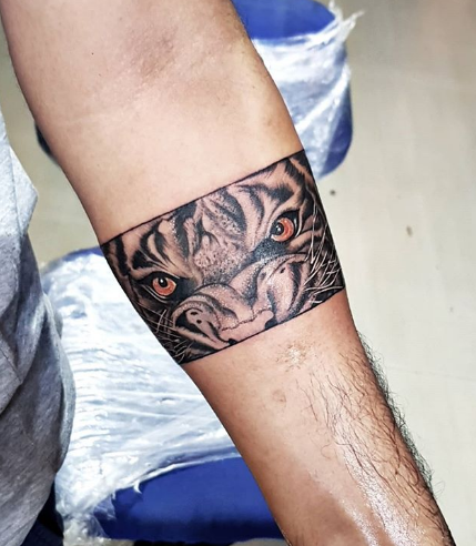 tiger eye tattoo on arm