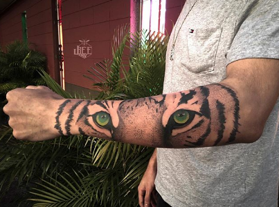 tiger eye tattoo on forearm