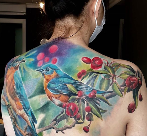 bird animal and plant tattoo on back