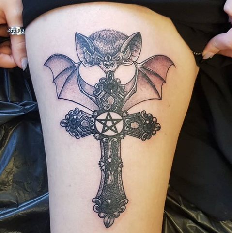 Gothic bat cross thigh tattoo