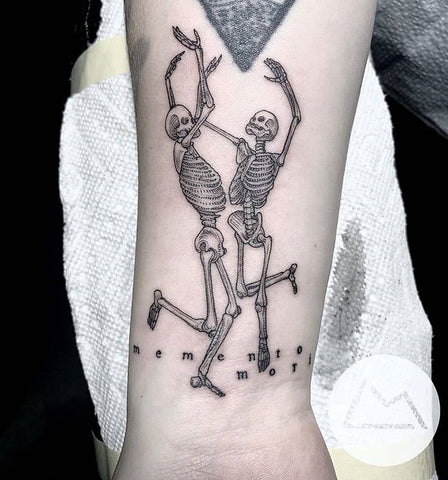 Matching fine line style dancing skeleton tattoos on