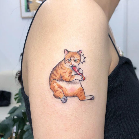 small orange cat arm tattoo