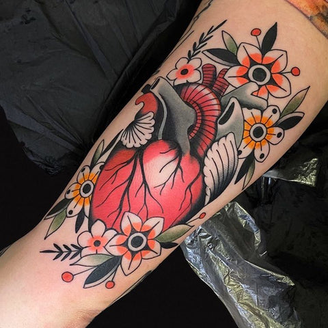 colored heart forearm tattoo