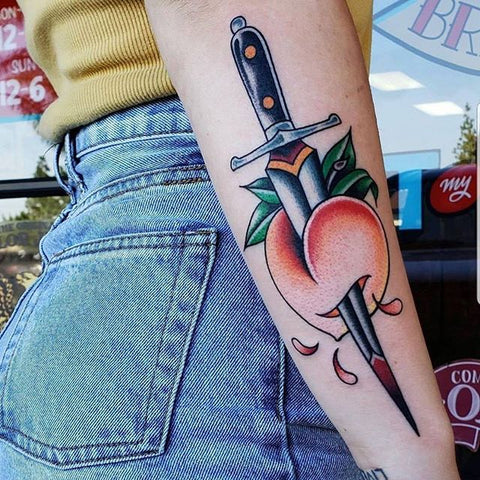peach dagger old school arm tattoo
