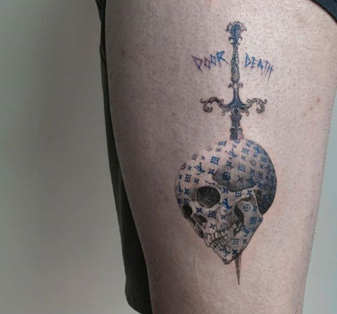 sword skull thigh tattoo