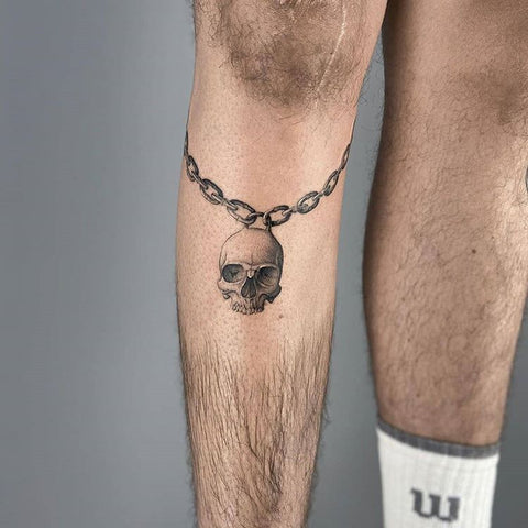 calf chain skull tattoo