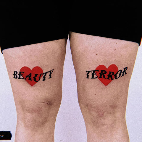 word heart thigh tattoo