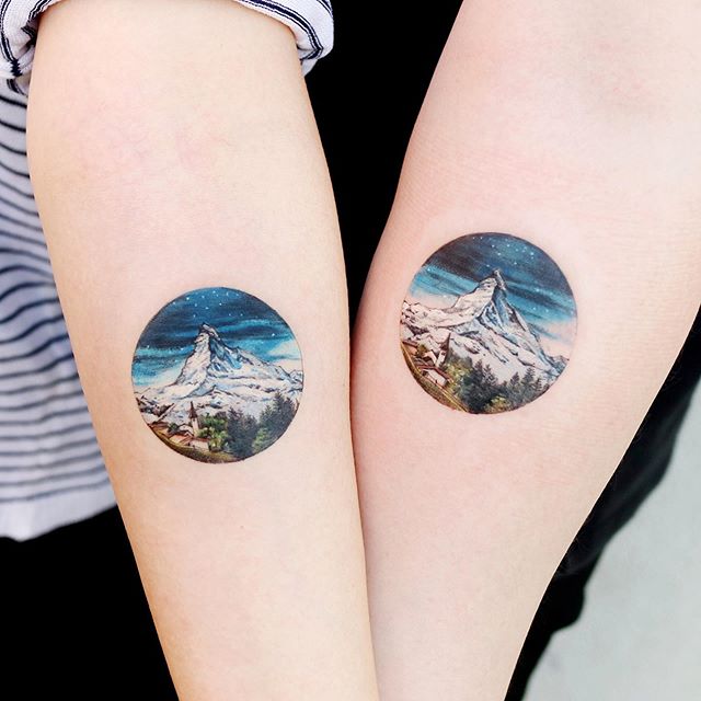 round frame nature mountain couple tattoo
