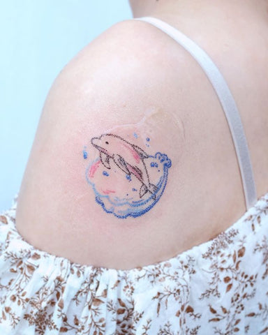 simple dolphin tattoo design on the shoulder