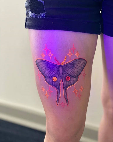 sparking butterfly thigh tattoo