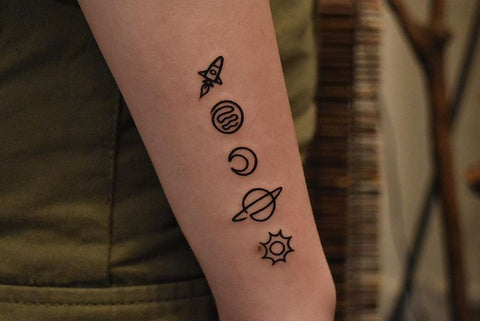 rocket sun moon universe tattoo on the forearm
