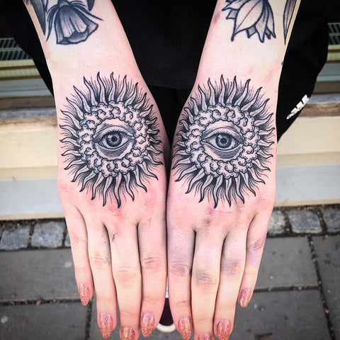 sun with an eye hand tattoo