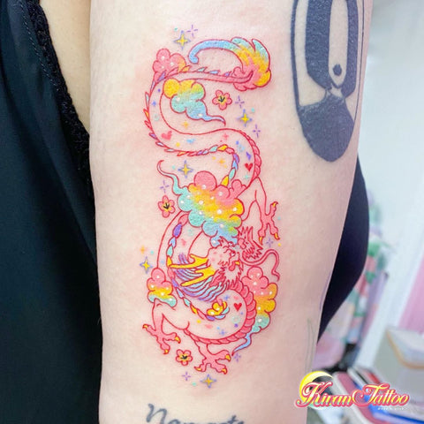 pink dragon tattoo on the arm