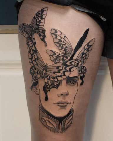 portrait and butterfly tattoo